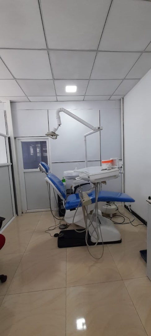 Dental treatment room with a blue chair and overhead light